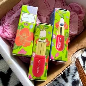Three pack Winky Lux flower lip balm with blue, yellow, and green flower